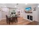 Bright dining area features wood floors, large windows and television on wall at 3333 Se 3Rd Ave, Ocala, FL 34471