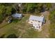 A charming residence featuring a spacious backyard, a quaint patio with outdoor seating, and a detached garage at 3333 Se 3Rd Ave, Ocala, FL 34471