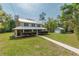 Two-story home with a metal roof, inviting porch, and large front yard. Includes a detached garage/workshop at 3333 Se 3Rd Ave, Ocala, FL 34471