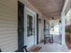 Welcoming front porch with rocking chair, ceiling fan, and visible Hello sign at 3333 Se 3Rd Ave, Ocala, FL 34471