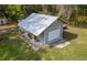 Aerial view of metal roof detached garage with roll up door at 3333 Se 3Rd Ave, Ocala, FL 34471