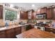 The kitchen is equipped with dark cabinets, stainless steel appliances, and wooden countertops at 3333 Se 3Rd Ave, Ocala, FL 34471