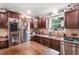 The kitchen is equipped with dark cabinets, stainless steel appliances, and wooden countertops at 3333 Se 3Rd Ave, Ocala, FL 34471