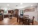 The kitchen features dark cabinetry and a farmhouse table, adjoined by a dining area at 3333 Se 3Rd Ave, Ocala, FL 34471