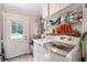 Well-equipped laundry room features white appliances, cabinets, and access door to exterior at 3333 Se 3Rd Ave, Ocala, FL 34471