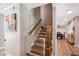 Open staircase features wood handrail and stone accents at 3333 Se 3Rd Ave, Ocala, FL 34471