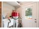 Utility room features sink, water heater, and access door to exterior at 3333 Se 3Rd Ave, Ocala, FL 34471