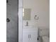 Modern bathroom featuring a marble tiled shower and white vanity at 124 Auburn Rd, Auburndale, FL 33823