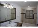 Beautiful bathroom featuring a tiled shower, tub, decorative inset and large mirror at 124 Auburn Rd, Auburndale, FL 33823
