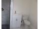 Bathroom featuring a stylish vanity, modern toilet, and tiled shower with glass door at 124 Auburn Rd, Auburndale, FL 33823