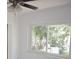 Bright bedroom with a ceiling fan and sliding window showcasing the backyard at 124 Auburn Rd, Auburndale, FL 33823