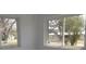 Bright bedroom with white walls and trim and two large windows at 124 Auburn Rd, Auburndale, FL 33823