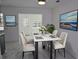 Dining room featuring a white marble table and eye-catching paintings at 124 Auburn Rd, Auburndale, FL 33823