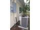 Exterior view of the home's AC unit surrounded by lush landscaping, ensuring efficient climate control at 124 Auburn Rd, Auburndale, FL 33823