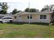 Charming single-story home featuring a well-maintained lawn and bright, neutral paint at 124 Auburn Rd, Auburndale, FL 33823