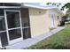 A shot of the home's exterior featuring a screened-in patio and a well-maintained yard at 124 Auburn Rd, Auburndale, FL 33823