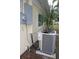 Image shows a new air conditioner and electrical box on the exterior of the home at 124 Auburn Rd, Auburndale, FL 33823