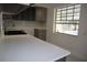 Modern kitchen featuring gray cabinets, quartz countertops, and stainless steel sink at 124 Auburn Rd, Auburndale, FL 33823