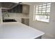 Bright kitchen featuring granite countertops, gray cabinets, and stainless steel appliances at 124 Auburn Rd, Auburndale, FL 33823
