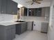 Modern kitchen featuring gray cabinets, quartz countertops, and stainless steel sink at 124 Auburn Rd, Auburndale, FL 33823