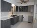 Modern kitchen featuring gray cabinets, quartz countertops, and stainless steel sink at 124 Auburn Rd, Auburndale, FL 33823