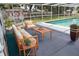 Screened lanai with outdoor seating overlooking the pool at 124 Auburn Rd, Auburndale, FL 33823