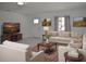 Bright living room featuring modern furnishings, neutral color palette, and ample natural light at 124 Auburn Rd, Auburndale, FL 33823