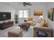 Inviting living room with neutral-toned furniture, artwork, and a large window at 124 Auburn Rd, Auburndale, FL 33823