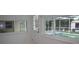 A well-lit sunroom features views of the screened in pool, perfect for enjoying indoor-outdoor living at 124 Auburn Rd, Auburndale, FL 33823