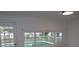 Bright room with sliding glass doors offer serene views of the sparkling pool, perfect for relaxation at 124 Auburn Rd, Auburndale, FL 33823