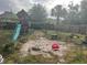 Backyard with a weathered playset and a sandy area at 1400 Hayward Ave, Deltona, FL 32738