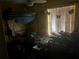 Bedroom with a bunk bed, a lot of clutter, and a sunny window at 1400 Hayward Ave, Deltona, FL 32738