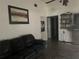 Living room with a black sofa, media center, and posters on the wall at 1400 Hayward Ave, Deltona, FL 32738