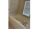 Clean bathroom with a soaking tub, tile surround, and chrome fixtures, offering a relaxing retreat at 9826 Poplar Pl, Orlando, FL 32827