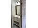 Stylish half bath featuring a modern vanity, framed mirror, and modern fixtures at 9826 Poplar Pl, Orlando, FL 32827