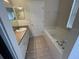 Bright bathroom featuring a soaking tub, vanity, and ample natural light from the window at 9826 Poplar Pl, Orlando, FL 32827
