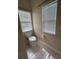 Cozy bathroom with a toilet and window offering natural light and ventilation at 9826 Poplar Pl, Orlando, FL 32827