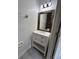 Stylish half bath featuring a modern vanity, framed mirror, and modern fixtures at 9826 Poplar Pl, Orlando, FL 32827