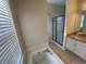 Bathroom featuring a bathtub, vanity, and shower at 9826 Poplar Pl, Orlando, FL 32827