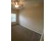 Comfortable bedroom with large window for natural light and plush carpet at 9826 Poplar Pl, Orlando, FL 32827
