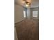 Comfortable bedroom with neutral carpet, ceiling fan, and ample natural light from the windows at 9826 Poplar Pl, Orlando, FL 32827