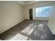 Bright bedroom featuring a large window and plush carpet at 9826 Poplar Pl, Orlando, FL 32827