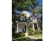 Charming two-story home featuring a cozy front porch with tasteful landscaping at 9826 Poplar Pl, Orlando, FL 32827