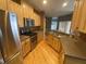 Modern kitchen featuring stainless steel appliances, wooden cabinets and hardwood floors at 9826 Poplar Pl, Orlando, FL 32827