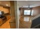 Open-concept kitchen flows into a living space with hardwood floors, creating a seamless and modern living area at 9826 Poplar Pl, Orlando, FL 32827