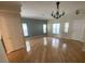 Spacious living room featuring hardwood floors and neutral paint, perfect for entertaining and relaxation at 9826 Poplar Pl, Orlando, FL 32827