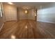 Large living room with hardwood floors and ample space, offering versatility for various furniture arrangements at 9826 Poplar Pl, Orlando, FL 32827