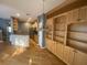 Bright living room featuring hardwood floors and built-in shelving, offering a spacious and inviting atmosphere at 9826 Poplar Pl, Orlando, FL 32827