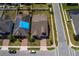 Aerial view showcasing the property's roof, well-kept lawn, landscaping, and brick driveway at 1720 Reflection Ln, St Cloud, FL 34771