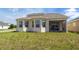 Home featuring a spacious backyard with a screened-in patio and large windows offering ample natural light at 1720 Reflection Ln, St Cloud, FL 34771